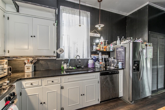 kitchen featuring dark countertops, plenty of natural light, appliances with stainless steel finishes, and a sink