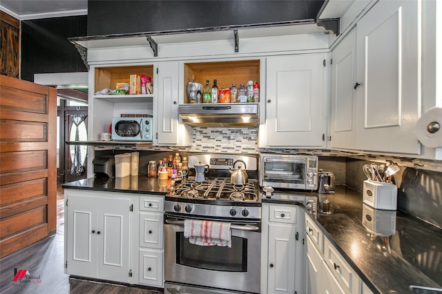 kitchen with decorative backsplash, open shelves, a toaster, extractor fan, and gas stove