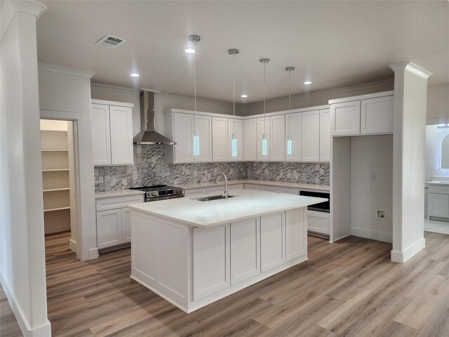 144 Shawnee Trl, Pottsboro, TX 75076 - kitchen with a sink, stainless steel range with electric cooktop, visible vents, backsplash, and wall chimney range hood