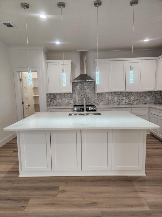 144 Shawnee Trl, Pottsboro, TX 75076 - kitchen featuring visible vents, wall chimney exhaust hood, a kitchen island with sink, tasteful backsplash, and white cabinetry