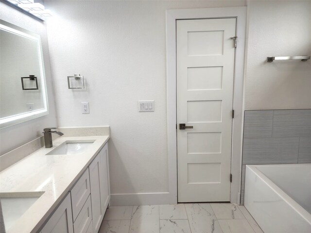 144 Shawnee Trl, Pottsboro, TX 75076 - bathroom with double vanity, marble finish floor, a bathing tub, and a sink