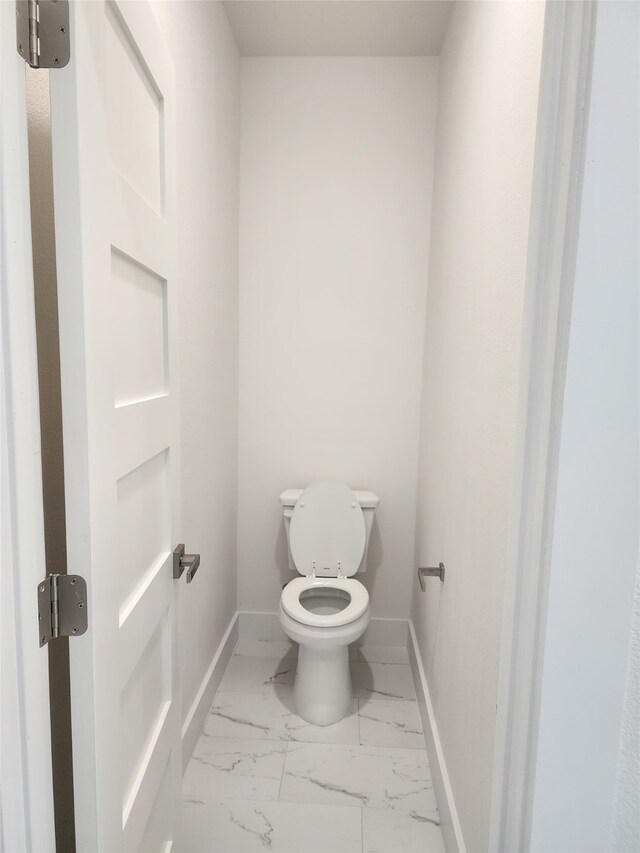 144 Shawnee Trl, Pottsboro, TX 75076 - bathroom featuring baseboards, marble finish floor, and toilet