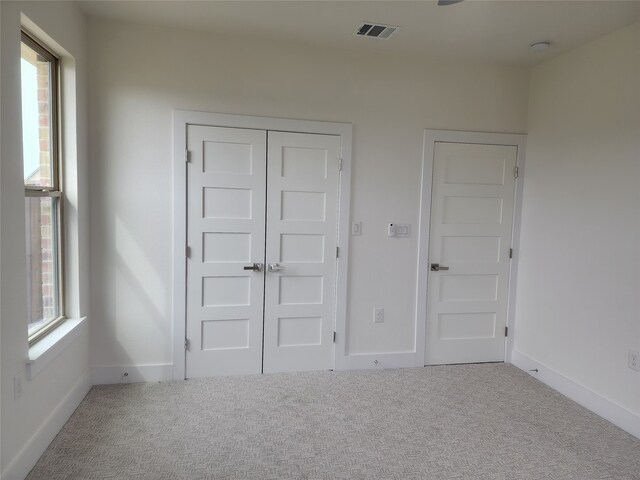 144 Shawnee Trl, Pottsboro, TX 75076 - unfurnished bedroom with a closet, carpet floors, visible vents, and baseboards