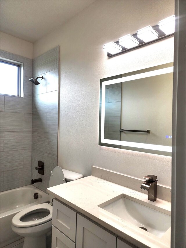 144 Shawnee Trl, Pottsboro, TX 75076 - bathroom featuring toilet, a textured wall, vanity, and tub / shower combination