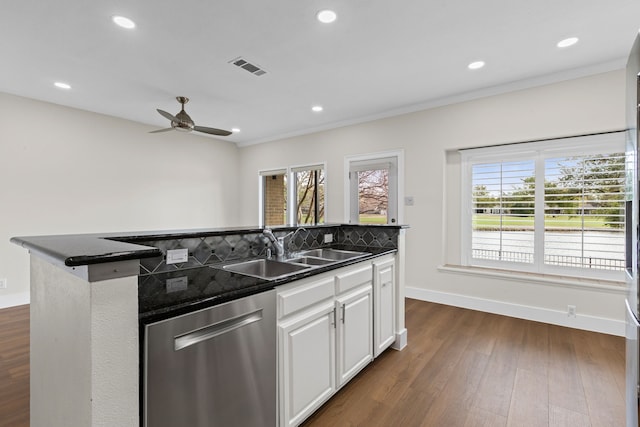 kitchen with stainless steel dishwasher, a wealth of natural light, a kitchen island with sink, and a sink