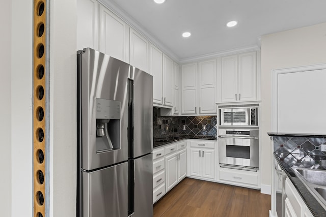 kitchen with white cabinetry, backsplash, dark countertops, and stainless steel appliances