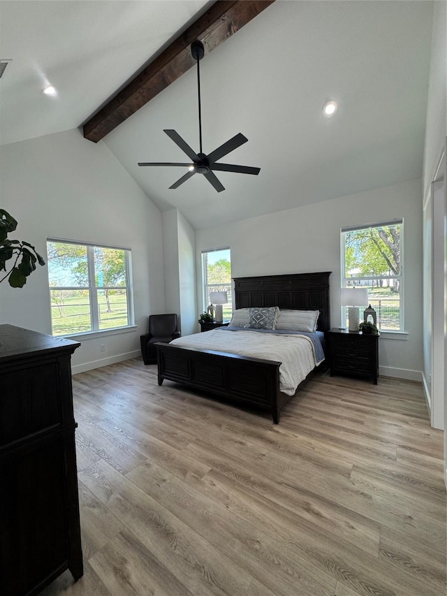 bedroom with light wood-type flooring, baseboards, beam ceiling, and ceiling fan