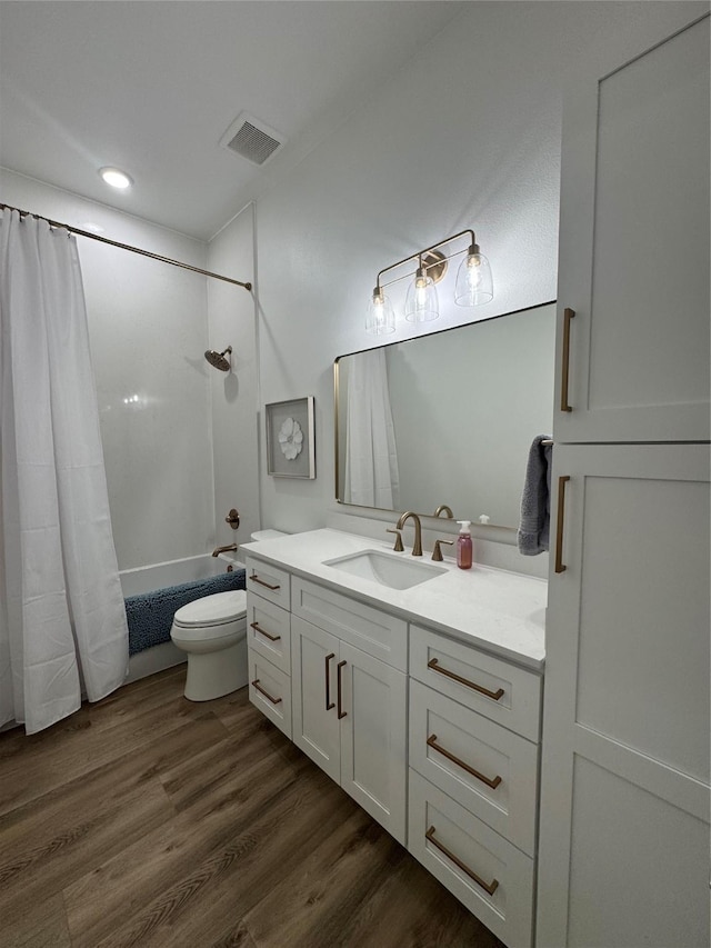 full bathroom featuring shower / bath combo, visible vents, toilet, vanity, and wood finished floors
