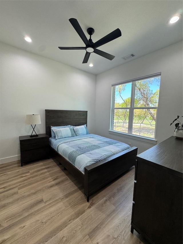 bedroom featuring visible vents, baseboards, recessed lighting, and light wood-style floors