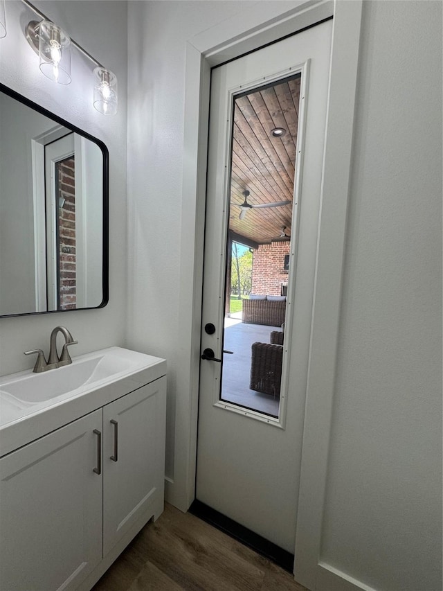 bathroom with vanity and wood finished floors