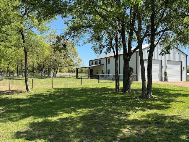 view of yard with an outbuilding, fence, and a detached garage