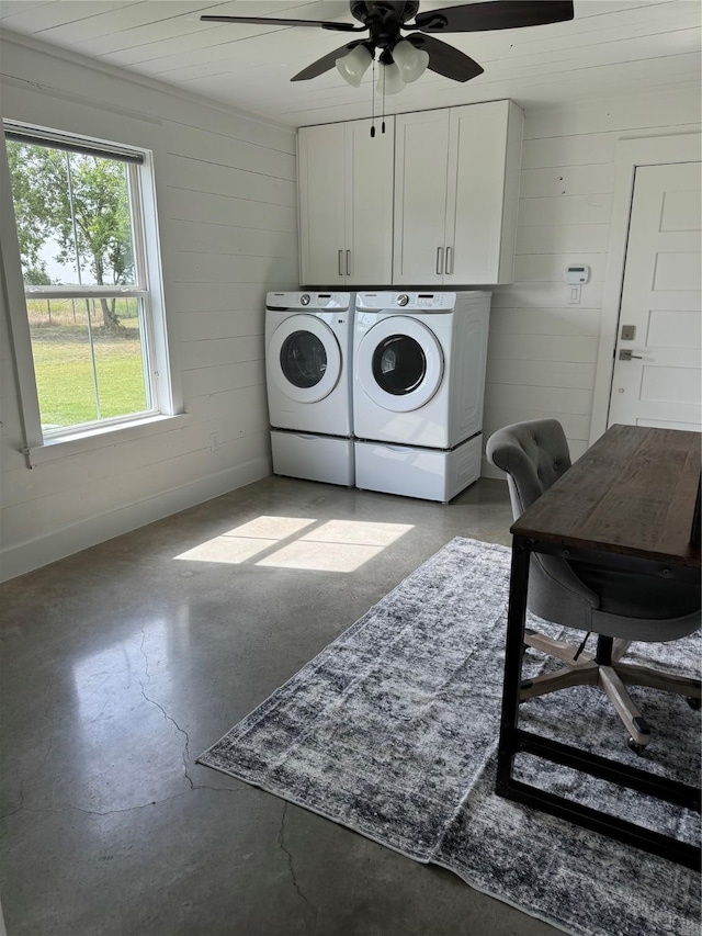 clothes washing area with ceiling fan, cabinet space, and washing machine and dryer