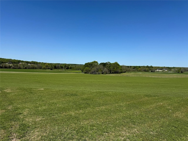 surrounding community with a yard and a rural view