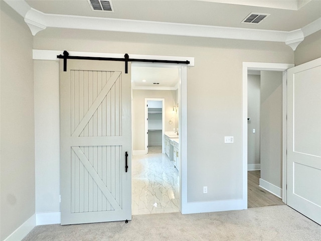 637 Caledonia Dr, Bossier City, LA 71111 - unfurnished bedroom with crown molding, carpet floors, visible vents, and a barn door