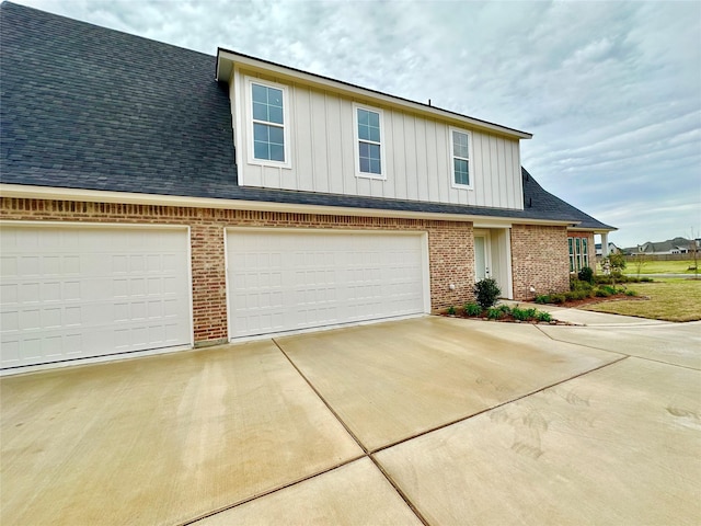 637 Caledonia Dr, Bossier City, LA 71111 - view of front of house with an attached garage, brick siding, board and batten siding, driveway, and a shingled roof