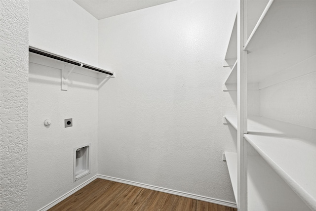 9173 Blackstone Dr, Providence Village, TX 76227 - laundry area featuring electric dryer hookup, dark wood-style flooring, and baseboards