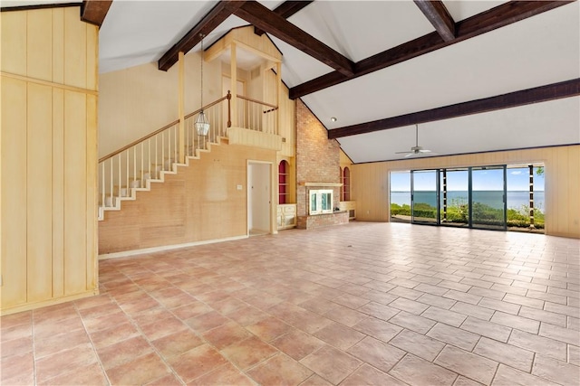 3709 Windmill Hill St, Waco, TX 76710 - unfurnished living room with high vaulted ceiling, wood walls, stairs, ceiling fan, and beam ceiling