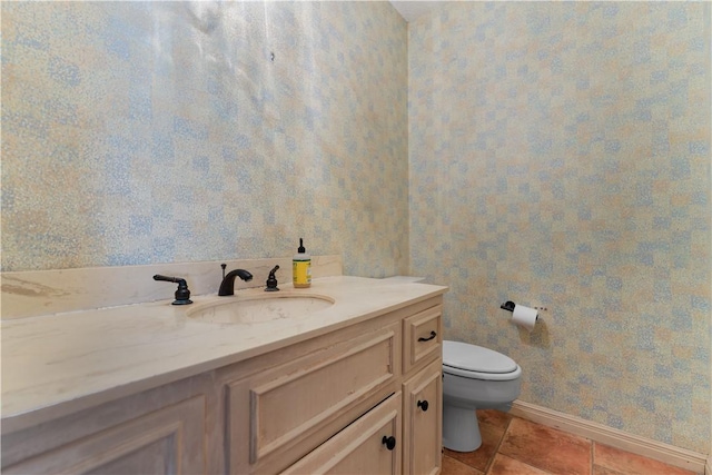 3709 Windmill Hill St, Waco, TX 76710 - bathroom with baseboards, wallpapered walls, toilet, vanity, and tile patterned flooring