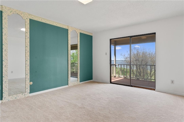 3709 Windmill Hill St, Waco, TX 76710 - carpeted empty room with wallpapered walls, baseboards, and a textured ceiling