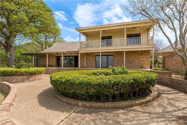 3709 Windmill Hill St, Waco, TX 76710 - exterior space with a balcony, board and batten siding, and brick siding
