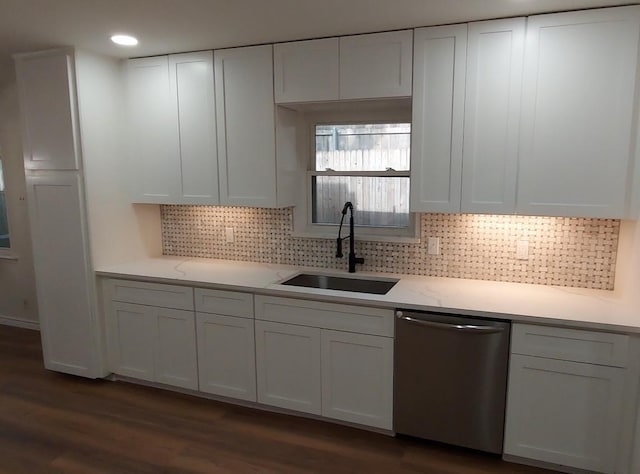 kitchen with dark wood-type flooring, white cabinetry, a sink, and dishwasher