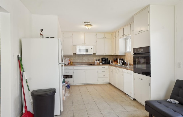 kitchen with backsplash, light tile patterned flooring, black appliances, visible vents, and a sink