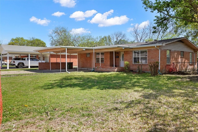 ranch-style house with brick siding, a front lawn, and a carport