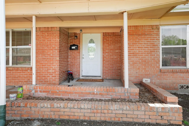 doorway to property with brick siding
