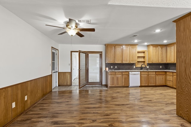 kitchen featuring a wainscoted wall, ceiling fan, visible vents, white dishwasher, and wood finished floors