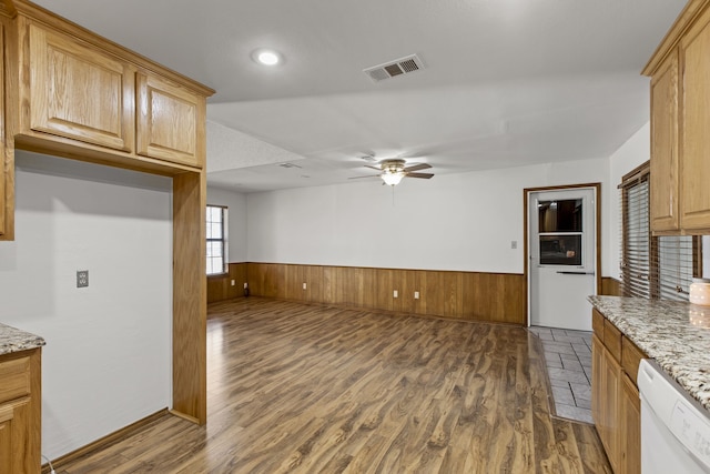 kitchen featuring dark wood finished floors, visible vents, dishwasher, a ceiling fan, and wainscoting