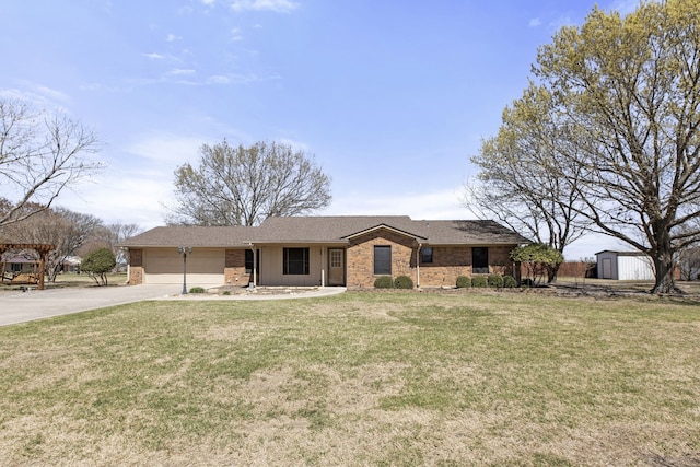 view of front of property with a front yard, concrete driveway, a shed, an outdoor structure, and an attached garage