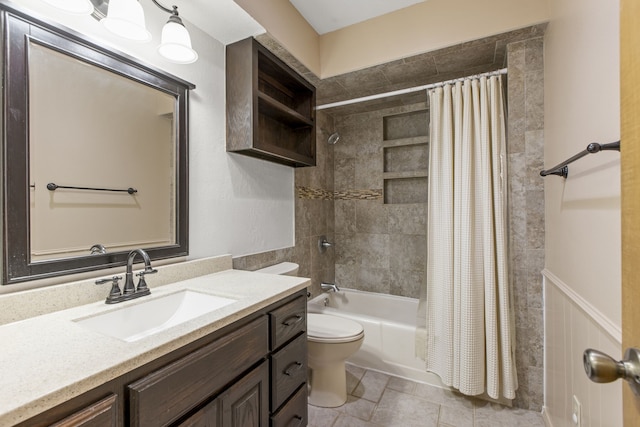 full bathroom with wainscoting, toilet, vanity, and shower / bathtub combination with curtain