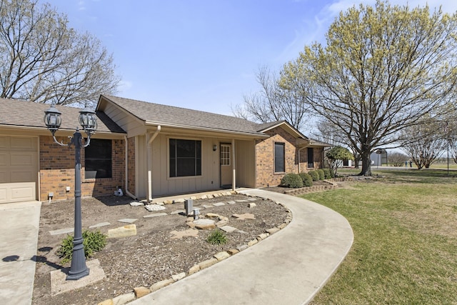 ranch-style home with brick siding, a shingled roof, a front lawn, and board and batten siding