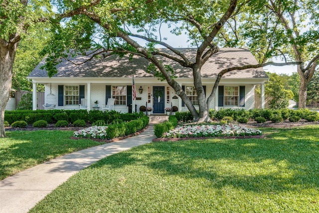 ranch-style home with a front lawn, brick siding, and covered porch