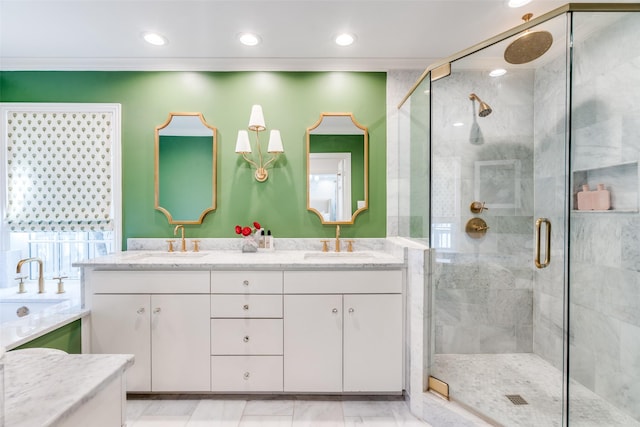 full bath featuring recessed lighting, double vanity, a stall shower, and a sink