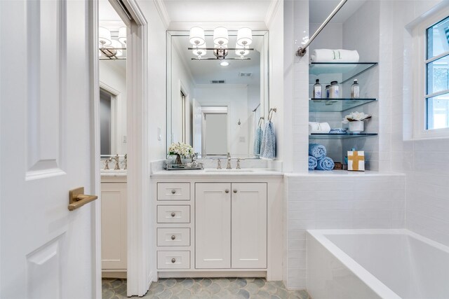 full bath featuring visible vents, vanity, a bath, crown molding, and a chandelier
