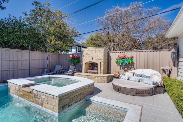 view of swimming pool featuring a fenced backyard, an outdoor stone fireplace, a patio, and an in ground hot tub