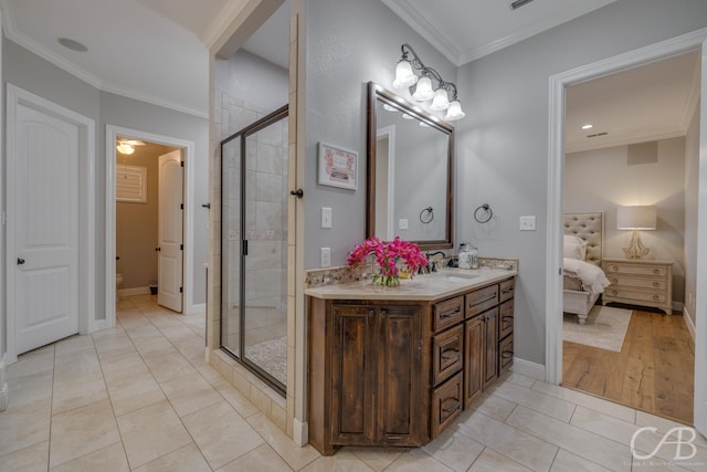 ensuite bathroom featuring ornamental molding, ensuite bath, a stall shower, and vanity
