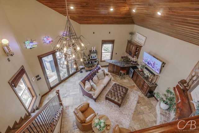 living room with wooden ceiling, an inviting chandelier, stone tile flooring, recessed lighting, and high vaulted ceiling