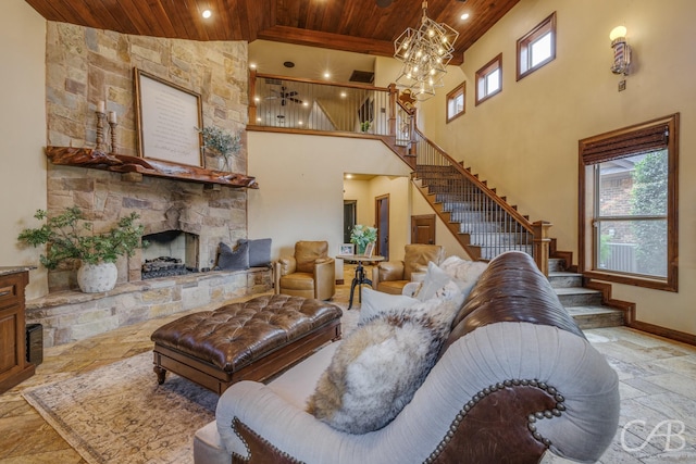 living room featuring plenty of natural light, stairway, a fireplace, and wooden ceiling