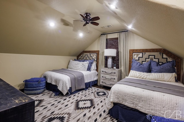 bedroom featuring visible vents, ceiling fan, wood finished floors, and vaulted ceiling