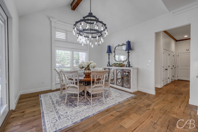 dining room with a notable chandelier, baseboards, vaulted ceiling with beams, and wood finished floors