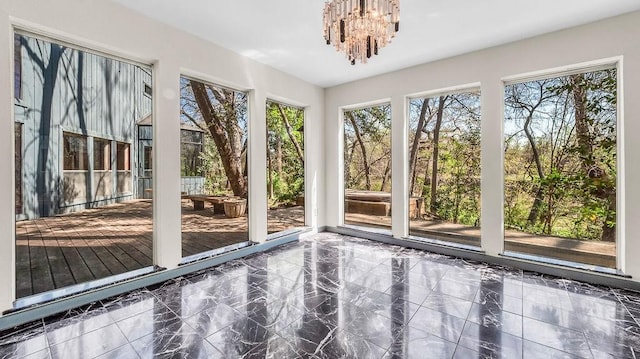 3724 Wooded Creek Dr, Farmers Branch, TX 75244 - unfurnished sunroom with plenty of natural light, a chandelier, marble finish flooring, and a deck