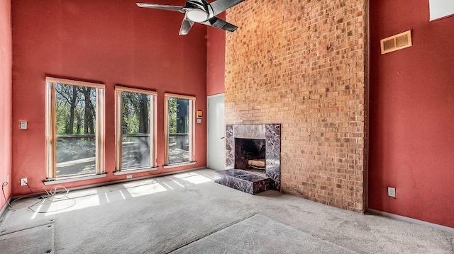 3724 Wooded Creek Dr, Farmers Branch, TX 75244 - unfurnished living room featuring carpet floors, a fireplace, a ceiling fan, and a towering ceiling