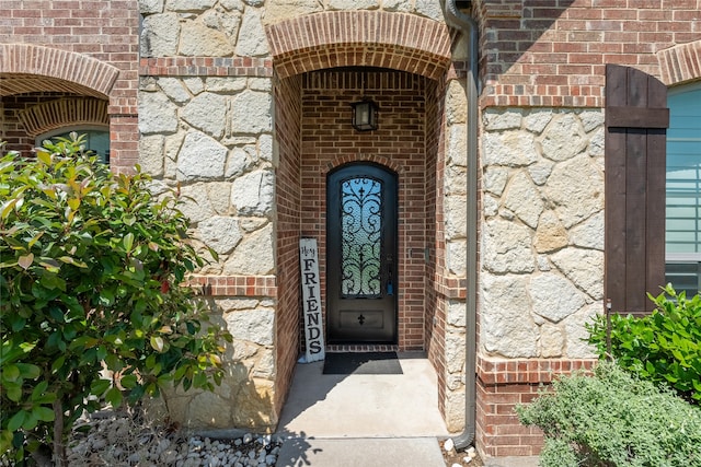 entrance to property with brick siding and stone siding