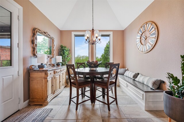 dining room featuring a chandelier and vaulted ceiling
