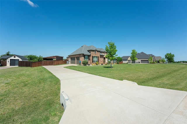 view of front of property with a garage, a front lawn, fence, brick siding, and concrete driveway