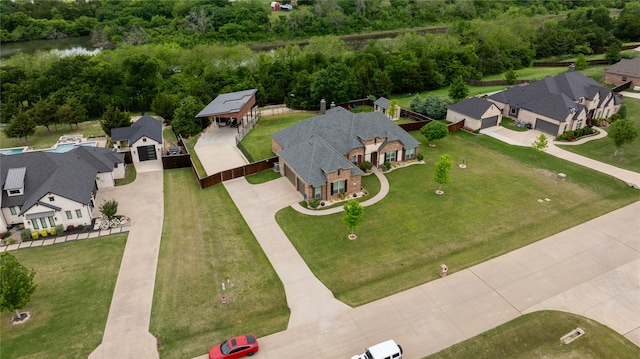 birds eye view of property with a water view and a residential view