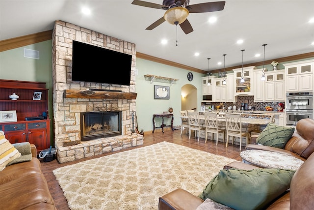 10790 White Settlement Rd, Fort Worth, TX 76108 - living area featuring ceiling fan, wood finished floors, arched walkways, ornamental molding, and baseboards