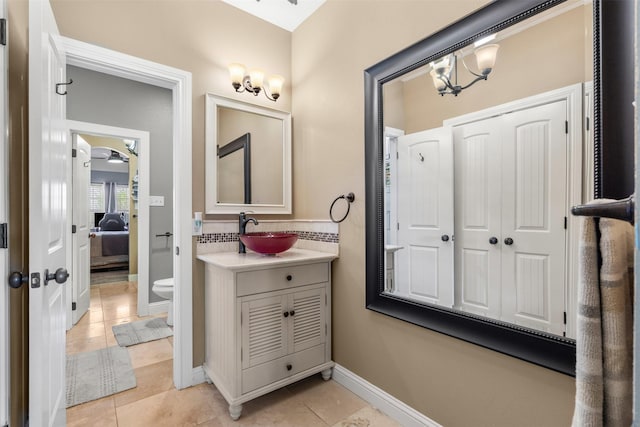 10790 White Settlement Rd, Fort Worth, TX 76108 - ensuite bathroom featuring tile patterned flooring, vanity, a chandelier, toilet, and baseboards